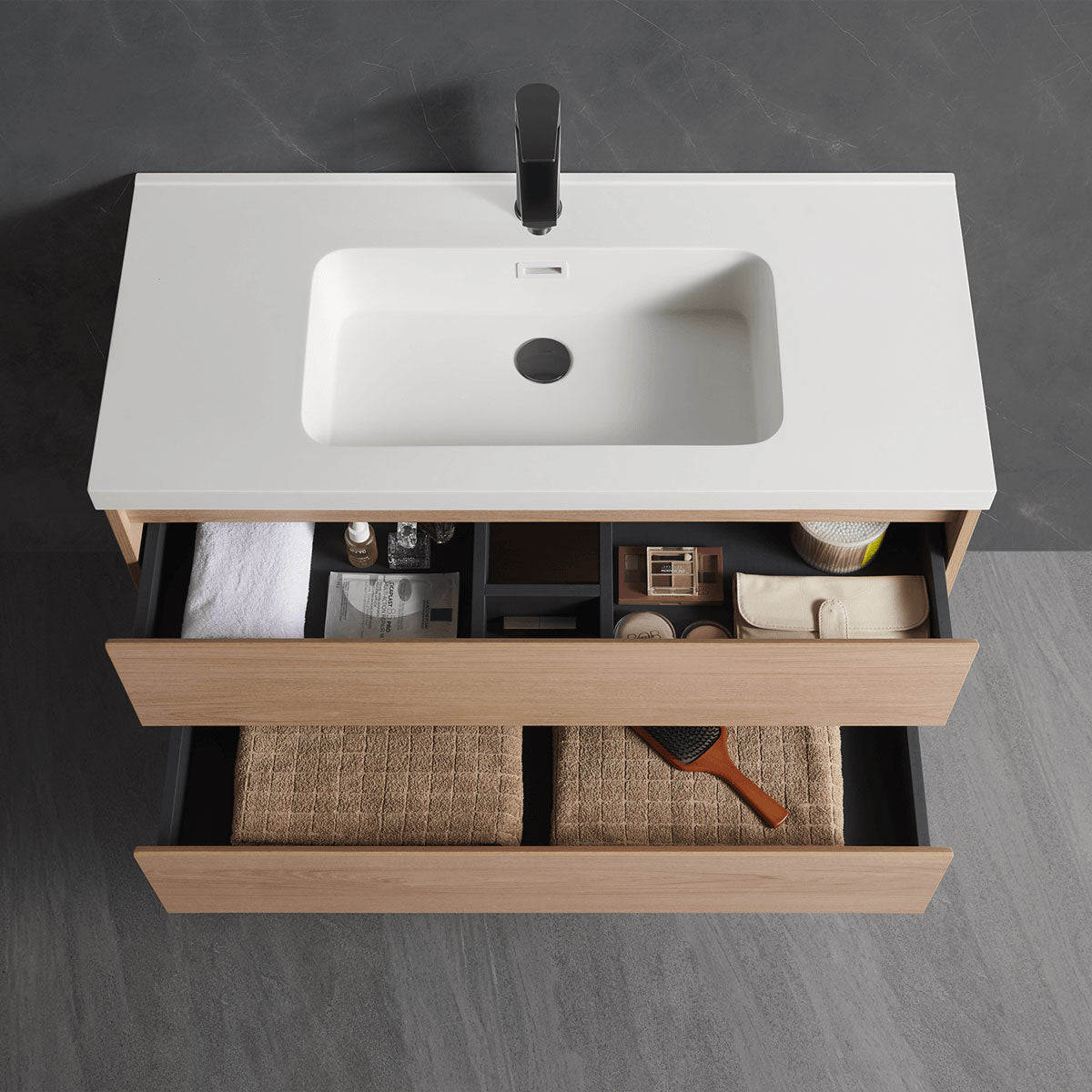 Open drawer storage close-up of floating single sink vanity, built-in compartments to organize bathroom toiletries