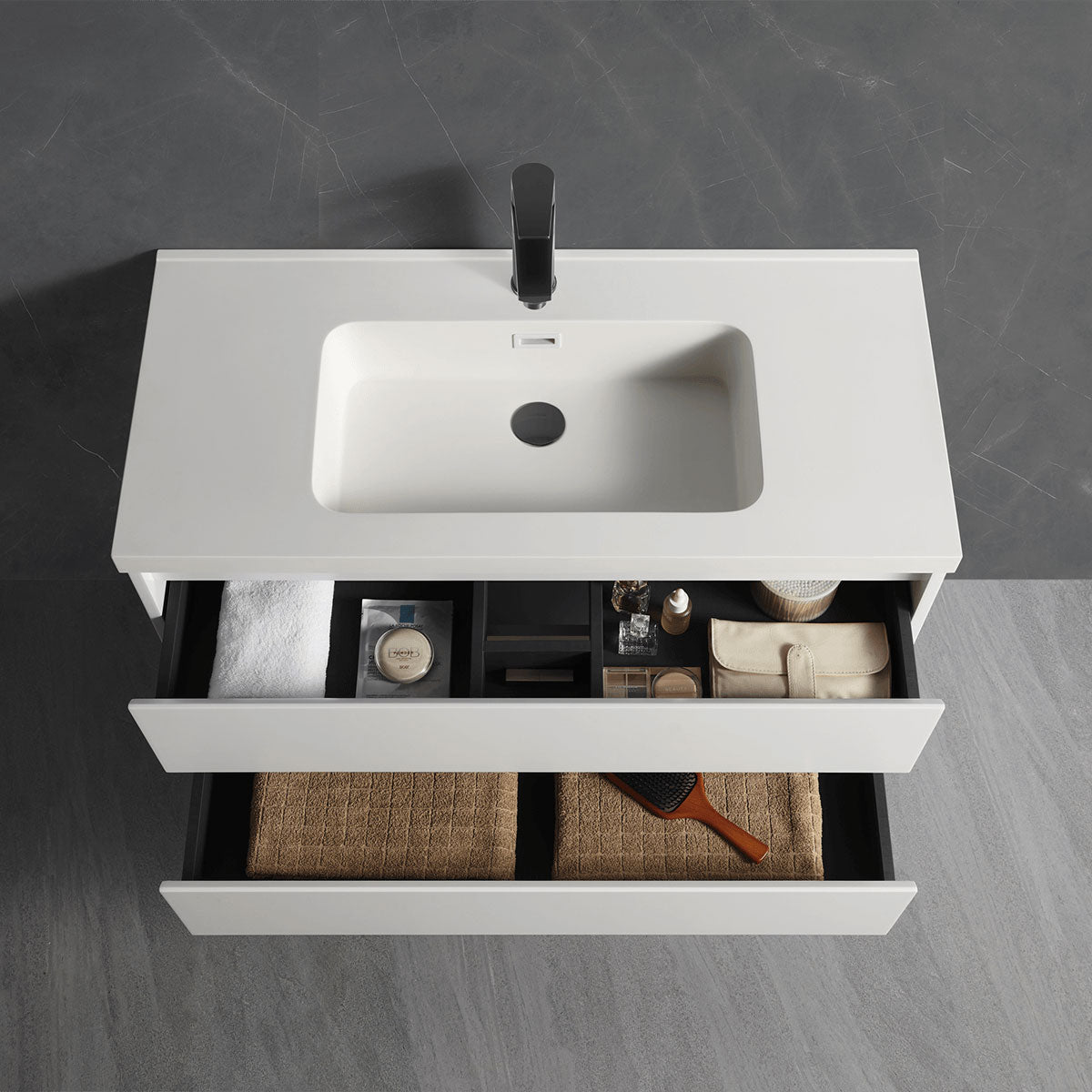 Pull-out drawer view of all-white floating vanity with seamless single sink countertop and tidy inner storage space