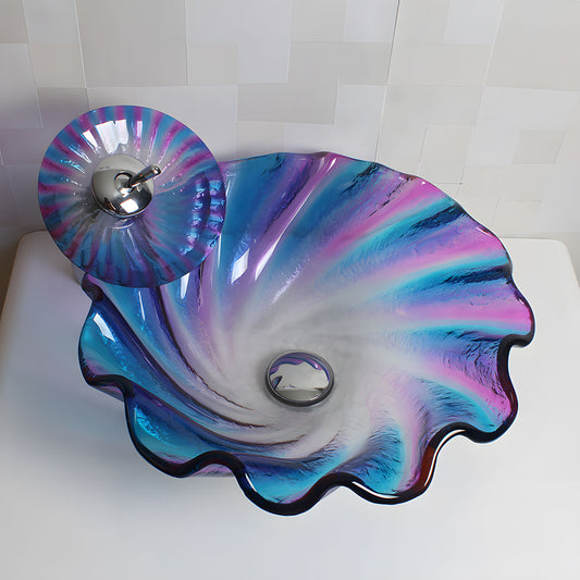 Top-down shot of ruffled flower shape gradient purple blue tempered glass vessel sink with matching colorful glass pop-up drain on light tile background