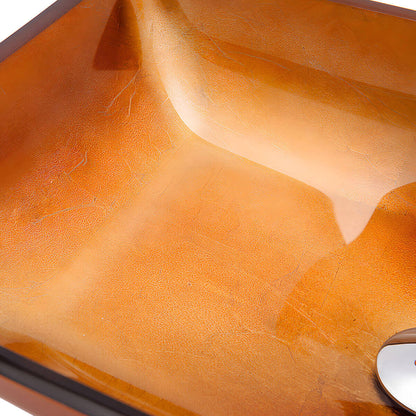 Close-up macro shot of smooth golden amber inner surface of tempered glass vessel sink showing soft translucent texture