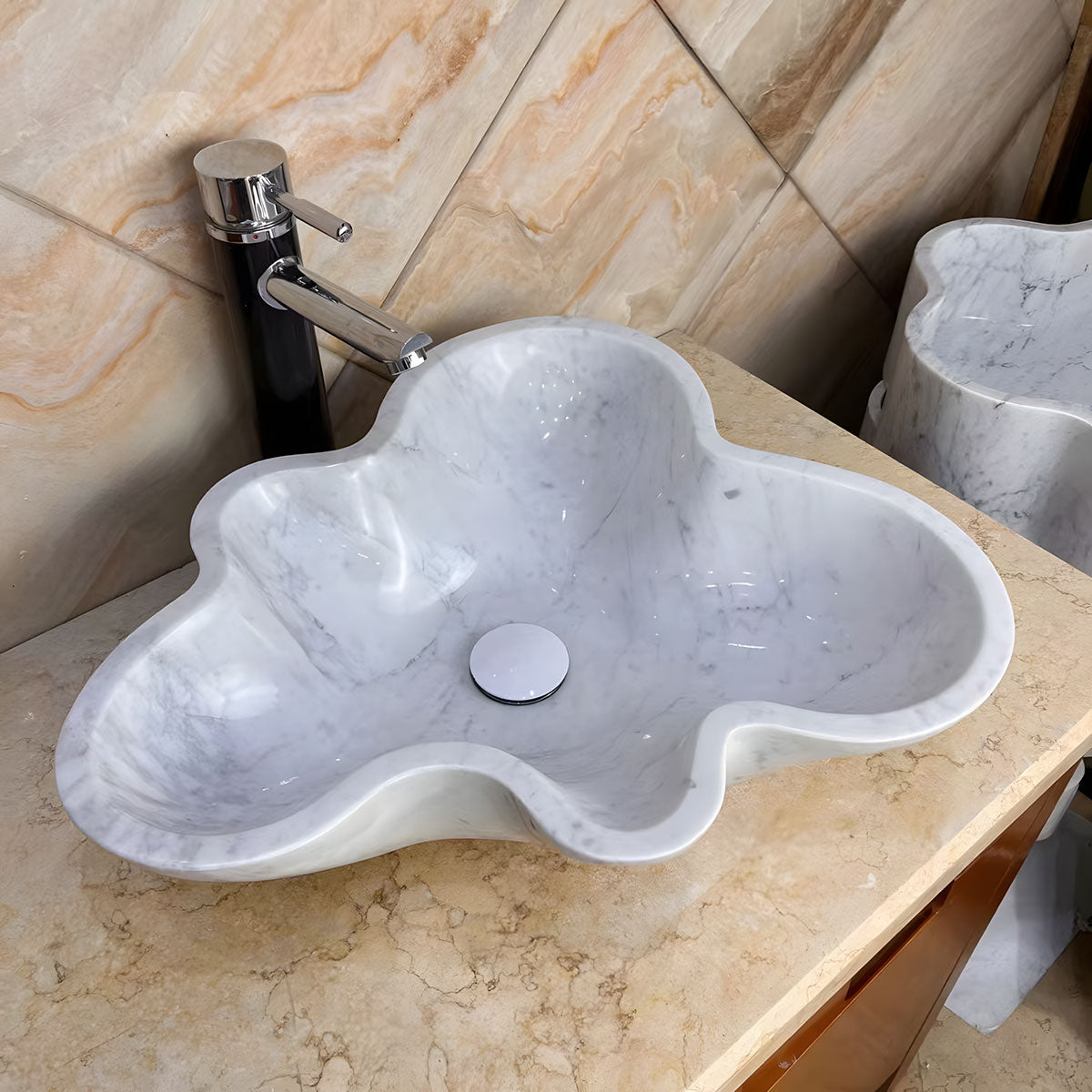 Irregular cloud shaped white natural marble vessel sink with grey veins above counter bathroom basin