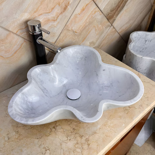 Irregular cloud shaped white natural marble vessel sink with grey veins above counter bathroom basin